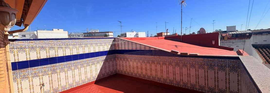 Terraza con suelo rojo y paredes de azulejos. SERVITRESS, agencia inmobiliaria en Valencia