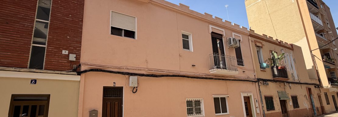 Fachada de casa de dos plantas de color salmón. SERVITRESS, experto en segregar casa por herencia